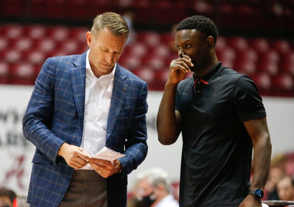 Alabama Head Coach Nate Oats  confers with Assistant Coach Antoine Pettway during an exhibition game in Coleman Coliseum Sunday, Oct. 24, 2021. [Staff Photo/Gary Cosby Jr.]