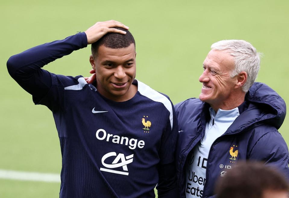 France’s forward Kylian Mbappe speaks with France’s head coach Didier Deschamps (AFP via Getty Images)