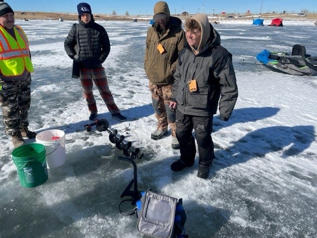 Ice fishing enthusiasts Connor Finch, rural Story County, second from the right, and Landon Broer, Slater, far right, were out early catching fish in the Zearing eighth annual ice fishing derby Saturday, Feb. 11, 2023. They said between 8 a.m. and 10:30 a.m., they caught more than 20 fish. Landon walked away with a first place finish in the crappie adult division with a 12-inch fish. Also pictured are Dave Skinner, left, and Michael Holm, center.