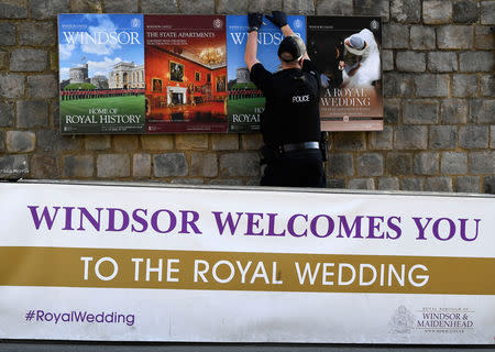 A police officer makes security checks around the castle, on the day before the royal wedding of Britain's Princess Eugenie and Jack Brooksbank, in Windsor, Britain, October 11, 2018. REUTERS/Toby Melville