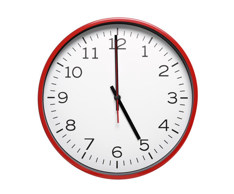 A clock with red trim displays the time as 10:10