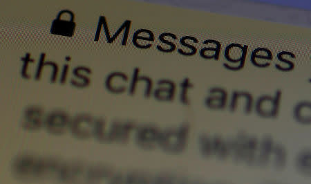 An encryption message is seen on the WhatsApp application on an iPhone in Manchester , Britain March 27, 2017. REUTERS/Phil Noble