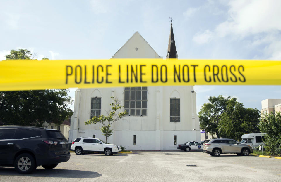 FILE - In this June 19, 2015 file photo, police tape surrounds the parking lot behind the AME Emanuel Church as FBI forensic experts work the crime scene, in Charleston, S.C. he new documentary, “Emanuel,” explores life after the tragic shooting took place on June 17, 2015, as family members, friends and the community try to heal through faith and forgiveness. (AP Photo/Stephen B. Morton, File)