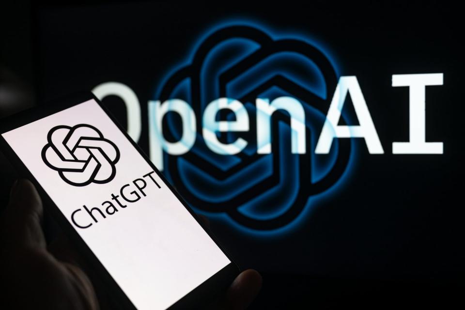 The OpenAI and ChatGPT logos with a smartphone in the foreground.