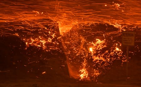 Firefighters battle a wind-driven wildfire in Sylmar, California