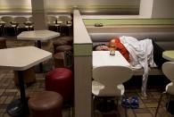 A man sleeps at a 24-hour McDonald's restaurant in Hong Kong, China November 10, 2015. A large number of homeless people sleeping on the street has long been been a problem in Hong Kong mainly due to its high rent and soaring property. In recent years, McDonald's 24-hour fast food shops opening all over the city have become popular alternatives for people, know as McRefugees or McSleepers, to spend the night in a safer and more comfortable way than on the street. Picture taken on November 10, 2015. McDonaldâ€™s Hong Kong said in a statement that it is accommodating to people staying long in the restaurant for their own respective reasons, while striking a good balance to ensure that customers enjoy their dining experience. REUTERS/Tyrone Siu