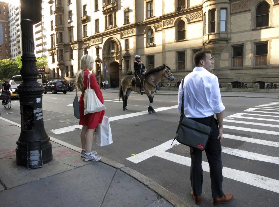 A policeman on a horse waits at a traffic light in the Upper West Side neighbourhood of New York June 20, 2013. New York City is iconic in any weather, but the warm season adds a special flavour to its bustling streets, leafy parks and world-famous skyline. The summer is about to draw to a close, as fall begins in the northern hemisphere with the Autumnal Equinox on September 22. Picture taken June 20, 2013. REUTERS/Gary Hershorn (UNITED STATES - Tags: CITYSCAPE SOCIETY) ATTENTION EDITORS: PICTURE 24 OF 40 FOR PACKAGE 'NYC - A SEASON IN THE CITY' SEARCH 'NYC HERSHORN' FOR ALL IMAGES