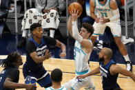 Charlotte Hornets' LaMelo Ball (2) looks to pass the ball as Minnesota Timberwolves' Jarrett Culver and Jordan McLaughlin, right, defend during the first half of an NBA basketball game Wednesday, March 3, 2021, in Minneapolis. (AP Photo/Jim Mone)