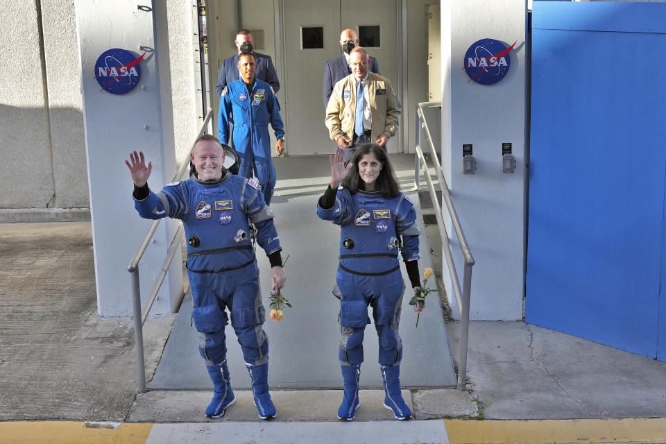 NASA astronauts Butch Wilmore, left, and Suni Williams waves to photographers after leaving the operations and checkout building for a trip to launch pad at Space Launch Complex 41 Wednesday, June 5, 2024, in Cape Canaveral, Fla. The two astronauts are scheduled to liftoff later today on the Boeing Starliner capsule for a trip to the international space station. . (AP Photo/Chris O'Meara)