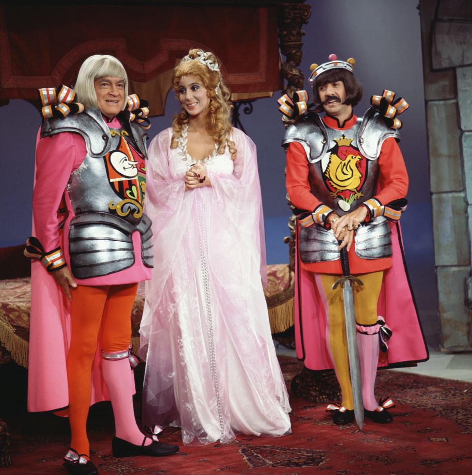 Comedian Bob Hope (L) appears dressed in medieval garb for a skit alongside married couple Cher (C) and Sonny Bono (R) on TV variety show “The Sonny & Cher Comedy Hour.”