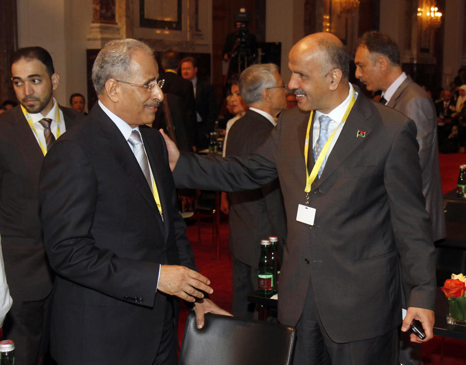 United Arab Emirates' Minister of Energy Mohamed bin Dhaen Al Hamli, left, talks with Libya's Minister of Oil and Gas Abdurahman Benyezza during a seminar of the Organization of the Petroleum Exporting Countries, OPEC, at Vienna's Hofburg palace, Austria, on Thursday, June 14, 2012. OPEC ministers are coming into a meeting Thursday deeply divided over how much crude to pump, with Saudi Arabia keen to keep a lid on prices, rival Iran pushing to cut production and Iraq expected to back Iran, its longtime foe under Saddam Hussein. (AP Photo/Ronald Zak)