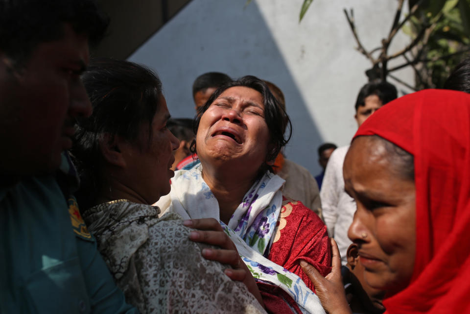 A Bangladeshi woman mourns the death of a relative in a fire, outside a morgue in Dhaka, Bangladesh, Thursday, Feb. 21, 2019. A devastating fire raced through at least five buildings in an old part of Bangladesh's capital and killed scores of people. (AP Photo/Rehman Asad)