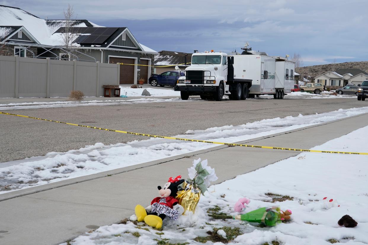 A makeshift memorial as a police crime scene trailer sits outside the Haight's home in Enoch, Utah, on January 5, 2023.