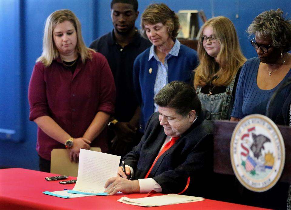 Illinois Gov. JB Pritzker signs a package of four bills addressing the Illinois teachers shortages at Springfield High School Wednesday April 27, 2022. [Thomas J. Turney/ The State Journal-Register]