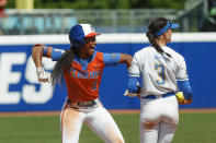 Florida's Cheyenne Lindsey (2) celebrates after reaching second base before UCLA infielder Briana Perez (3) could make a tag during the fifth inning of an NCAA softball Women's College World Series game on Sunday, June 5, 2022, in Oklahoma City. (AP Photo/Alonzo Adams)