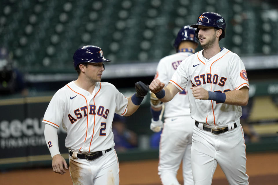 Houston Astros' Kyle Tucker (30) celebrates with Alex Bregman (2) after both scored on Tucker's home run against the Texas Rangers during the second inning of a baseball game Thursday, Sept. 17, 2020, in Houston. (AP Photo/David J. Phillip)