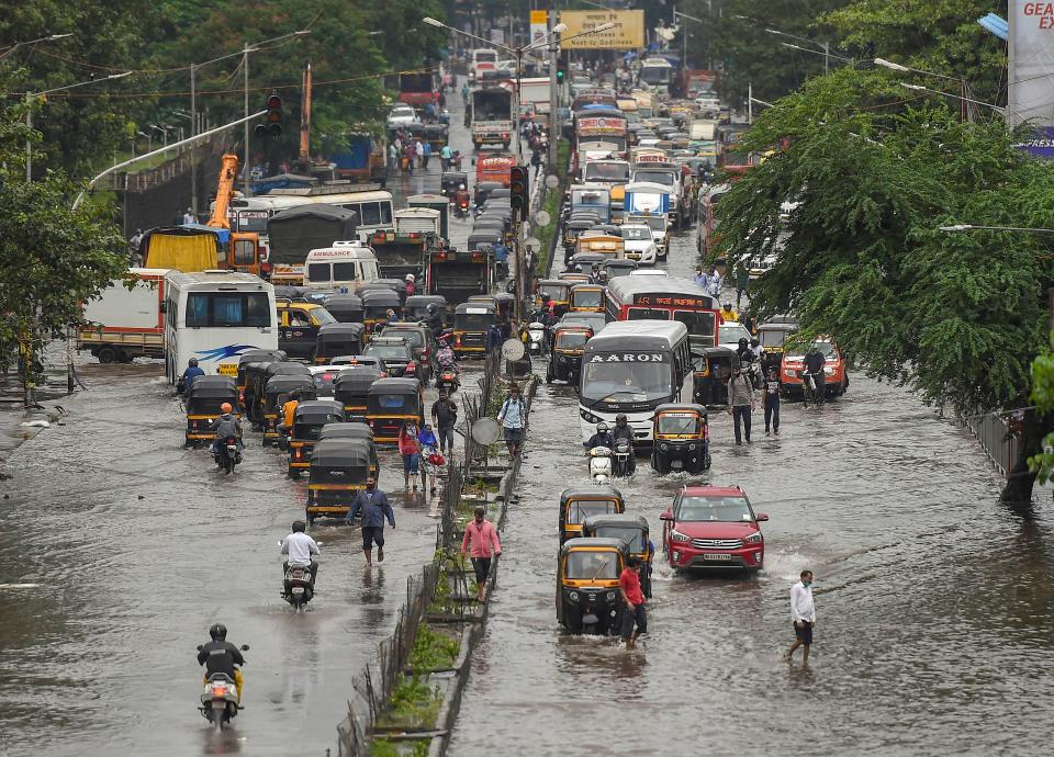 Vehicles move on waterlogged LBS road after heavy monsoon rain, at Kurla in Mumbai, Wednesday, 23 September.