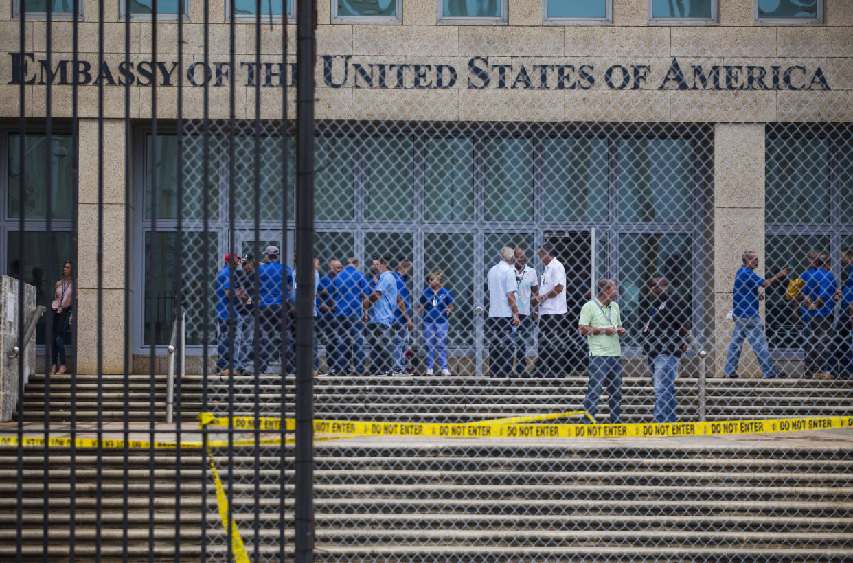 Staff stand around in front of the United States Embassy building in Havana, Cuba. 