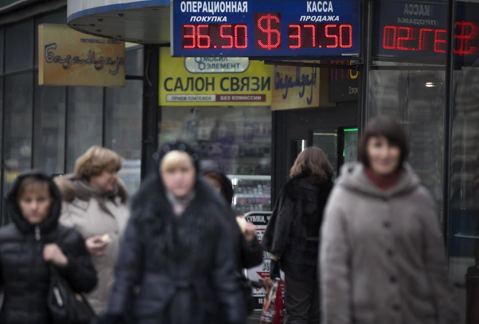 People walk past a currency exchange office in downtown Moscow, Russia, Monday, March 3, 2014. Russia's markets have dropped about 10 percent and its currency has fallen to its lowest point ever against the dollar and the euro because of the crisis in neighboring Ukraine. Russia intervened over the weekend to take control of Crimea, a Ukrainian peninsula with strategic importance, and the new government in Kiev fears a wider invasion. (AP Photo/Alexander Zemlianichenko)