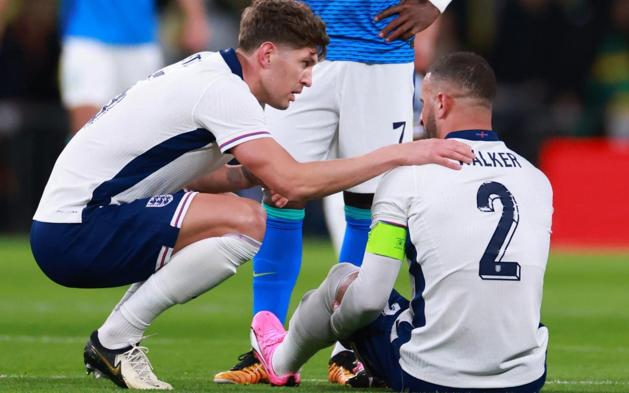 John Stones with the injured Kyle Walker of England during the international friendly match between England and Brazil