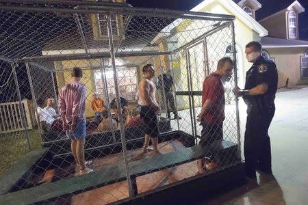 People are taken into custody at the Bay County Sheriff's Office mobile booking unit during spring break festivities in Panama City Beach, Florida March 12, 2015. REUTERS/Michael Spooneybarger