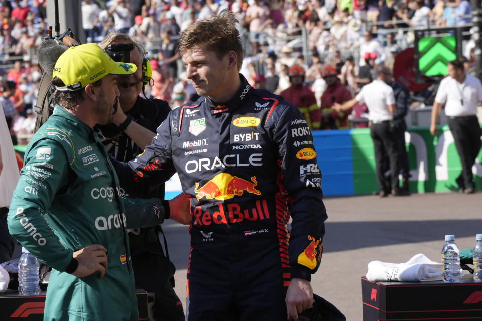 Red Bull driver Max Verstappen of the Netherlands, right, speaks with Aston Martin driver Fernando Alonso of Spain at the end of the Formula One qualifying session at the Monaco racetrack, in Monaco, Saturday, May 27, 2023. The Formula One race will be held on Sunday with Verstappen at pole position. (AP Photo/Luca Bruno)