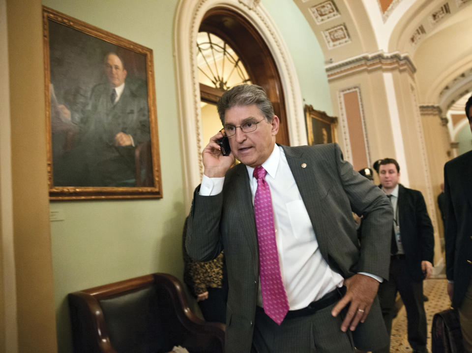Sen. Joe Manchin, D-W.Va., taks on his phone just off the Senate floor following lunch with fellow Democrats, at the Capitol in Washington, Tuesday, Oct. 15, 2013. (AP Photo/J. Scott Applewhite)