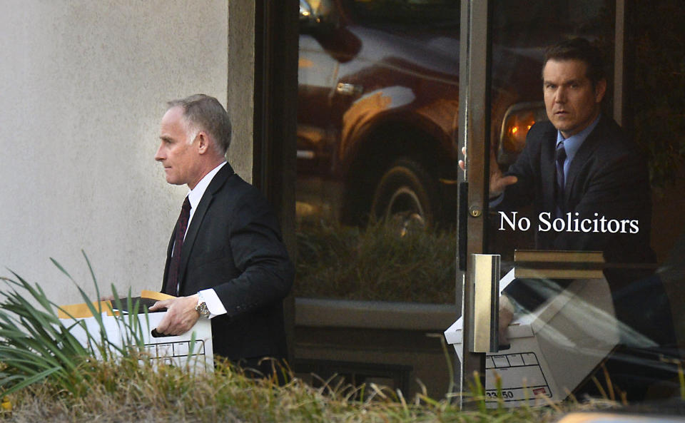 In this photo taken on March 26, 2014, officials carry boxes from the E-Z Parking offices in uptown Charlotte, N.C., as they continue their investigation into Charlotte mayor Patrick Cannon. U.S. Attorney Anne Tompkins said Wednesday, March 26, 2014, that Cannon is facing theft and bribery charges. Tompkins says Cannon solicited and accepted bribes from undercover FBI agents posing as real estate developers who wanted to do business in Charlotte. (AP Photo/The Charlotte Observer, Todd Sumlin) MAGS OUT; TV OUT, LOCAL PRINT OUT (CHARLOTTE BUSINESS JOURNAL, CREATIVE LOAFLING, CHARLOTEE WEEKLY, MECHLENBURG TIMES, CHARLOTTE MAGAZINE, CHARLOTTE PARENTS)