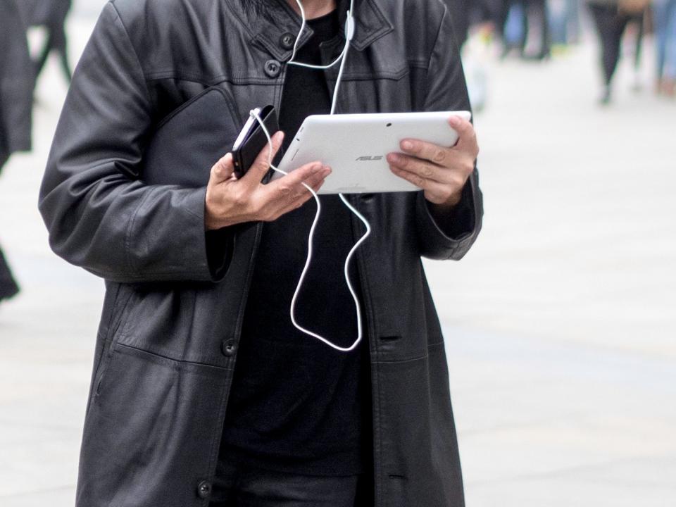 man tablet public trench coat leather ipad