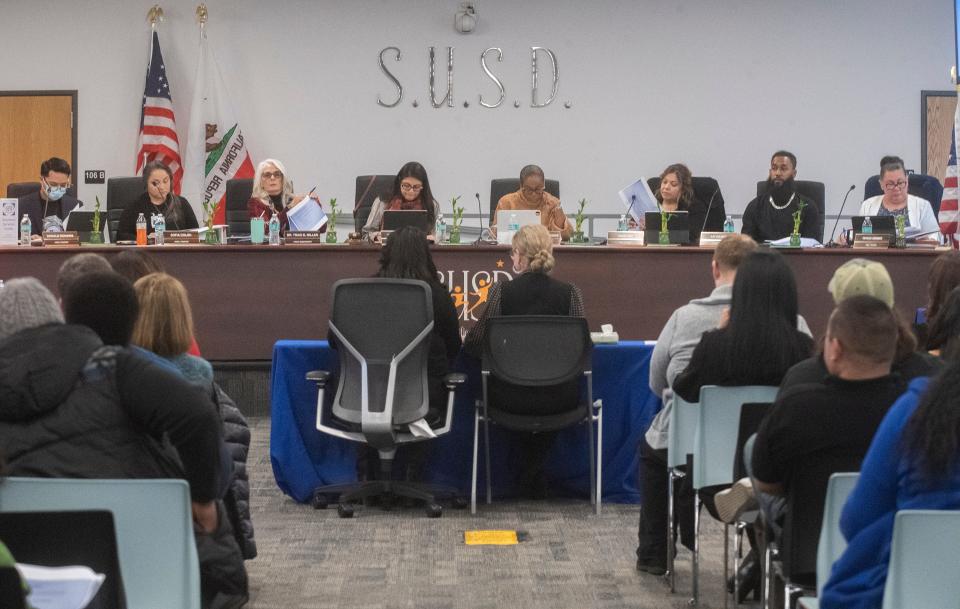 Stockton Unified School District interim chief business official Joann Juarez, seated center left, and Dr. Susana Ramirez, interim assistant superintendent, educational services department, give a business and finance presentation to the SUSD board during a special study session at the SUSD Arthur Coleman Jr. Administrative Complex in downtown Stockton on Tuesday, Jan. 24, 2023. 