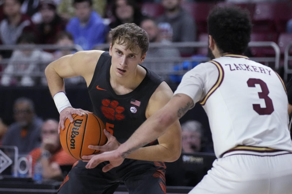 Clemson forward Hunter Tyson (5) looks to pass while covered by Boston College guard Jaeden Zackery (3) during the first half of an NCAA college basketball game, Tuesday, Jan. 31, 2023, in Boston. (AP Photo/Charles Krupa)