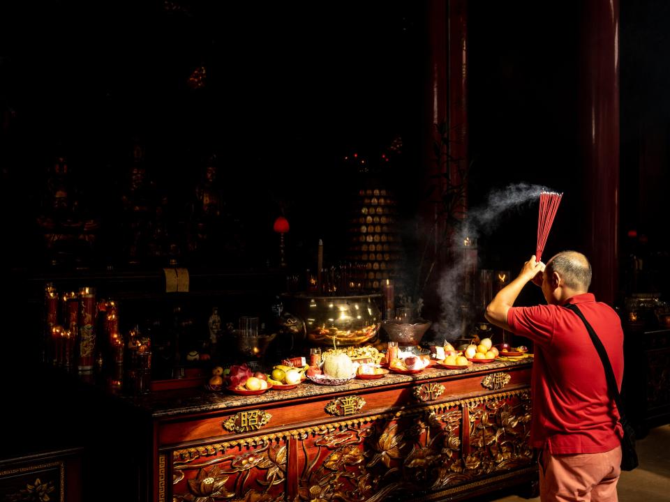 A Chinese-Indonesian man prays during Chinese New Year celebration on January 22, 2023.