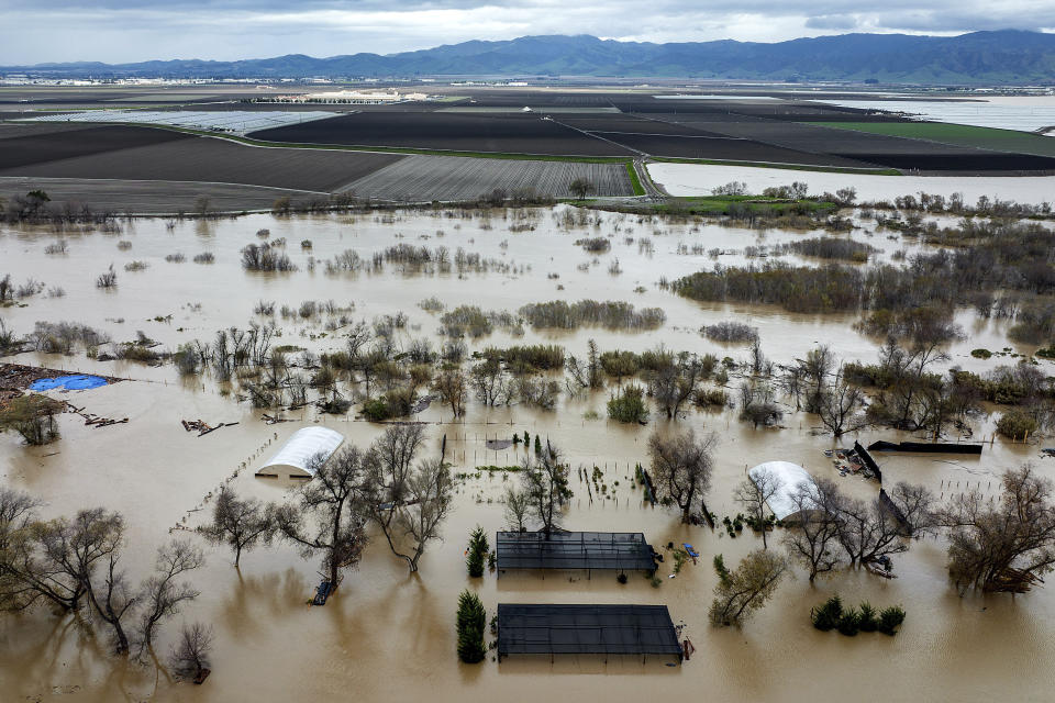 FILE - Floodwaters cover a property along River Rd. in Monterey County, Calif., as the Salinas River overflows its banks on Jan. 13, 2023. California officials announced on Thursday, Jan. 26, 2023, that public water agencies will get 30% of what they asked for instead of 5%. The increase is because of a spate of recent storms that have helped replenish some of the state's reservoirs that had been impacted by a severe drought. (AP Photo/Noah Berger, File)