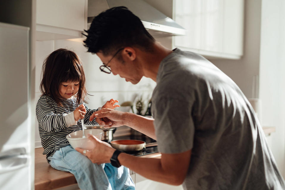 Young Asian father and daughter cooking together in kitchen at home (Oscar Wong / Getty Images)