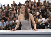 FILE - Marion Cotillard poses for photographers at the photo call for the film 'Brother and Sister' at the 75th international film festival, Cannes, southern France, Saturday, May 21, 2022. Oscar-winning actresses Marion Cotillard and Juliette Binoche, as well as other French stars of screen and music, filmed themselves chopping off locks of their hair in a video posted Wednesday Oct.5, 2022 in support of protesters in Iran. (AP Photo/Petros Giannakouris, File)