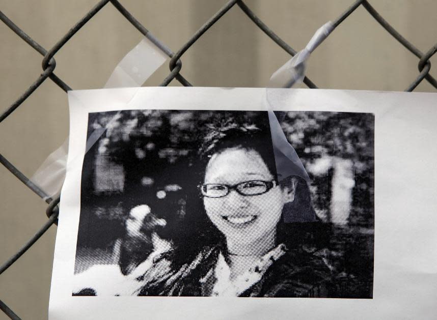 A photocopy showing Elisa Lam of Canada is displayed at a street memorial across the Cecil Hotel in Los Angeles Thursday, Feb. 21, 2013. Lam, a Canadian tourist, who was last seen last month. Los Angels Police say the body of a woman was found wedged in one of the water tanks on the roof was that of a missing Canadian guest. Investigators used body markings to identify 21-year-old Elisa Lam, police spokeswoman Officer Diana Figueroa said late Tuesday. (AP Photo/Damian Dovarganes)