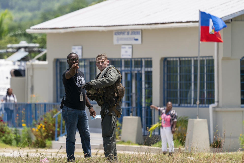 U.S. Marine Cpl. Jacob Simons, right, coordinates the unloading of the food from a VM-22 Osprey with a Haitian aid worker at Jeremie Airport, Saturday, Aug. 28, 2021, in Jeremie, Haiti. The VMM-266, "Fighting Griffins," from Marine Corps Air Station New River, from Jacksonville, N.C., are flying in support of Joint Task Force Haiti after a 7.2 magnitude earthquake on Aug. 22, caused heavy damage to the country. (AP Photo/Alex Brandon)