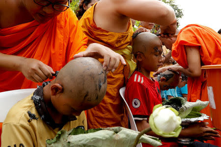 Boys have their hair shaved by monks in preparation for an annual Poy Sang Long celebration, a traditional rite of passage for boys to be initiated as Buddhist novices, in Mae Hong Son, Thailand, April 2, 2018. REUTERS/Jorge Silva