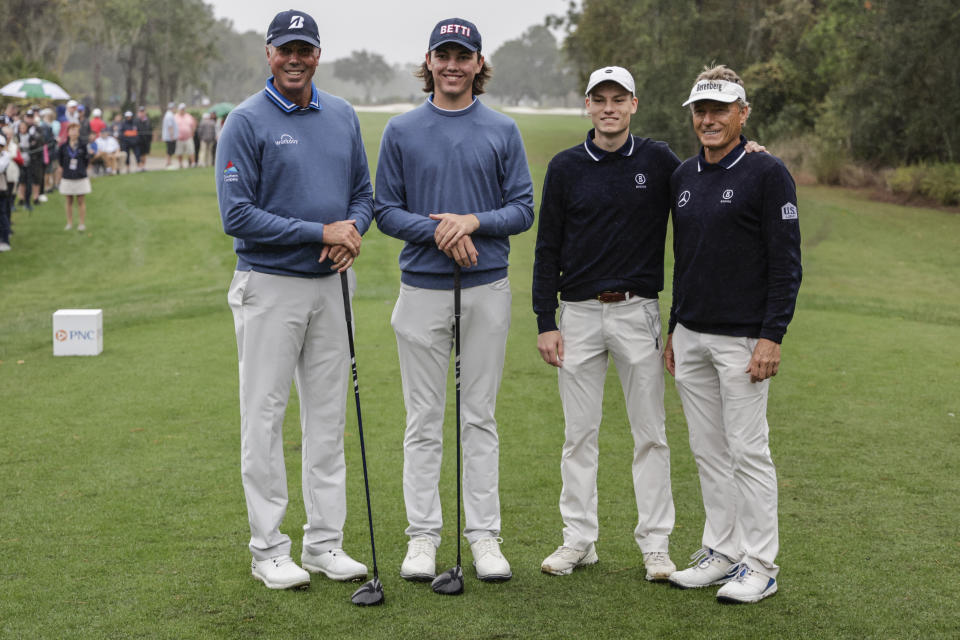 First round leaders Matt Kuchar, left; and son Cameron, center left; Jason Lander, center right; and father Bernard, right; stand at the first tee during the final round of the PNC Championship golf tournament, Sunday, Dec. 17, 2023, in Orlando, Fla. (AP Photo/Kevin Kolczynski)