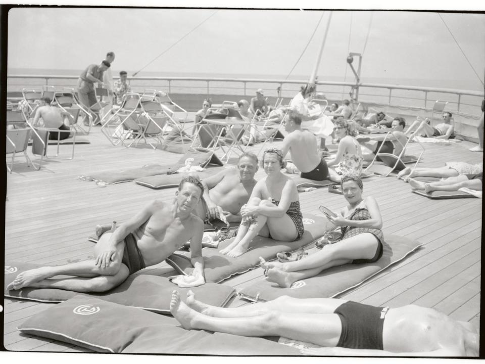 Passengers sunbathing on the deck of the French ocean liner Normandie, 1937.
