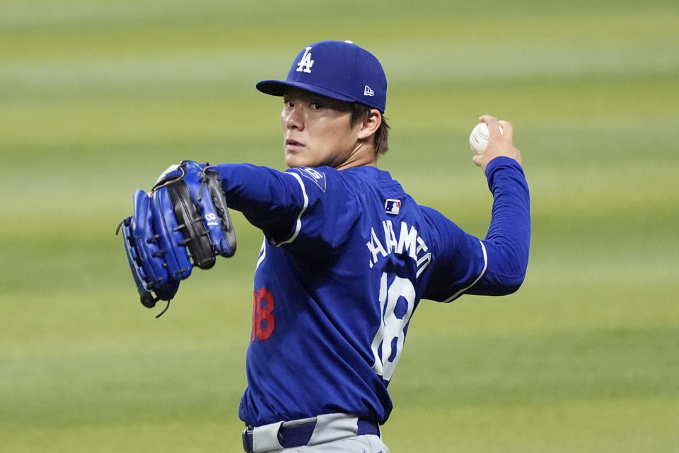 Injured Los Angeles Dodgers starting pitcher Yoshinobu Yamamoto, of Japan, warms up prior to a baseball game against the Arizona Diamondbacks, Sunday, Sept. 1, 2024, in Phoenix. (AP Photo/Ross D. Franklin)