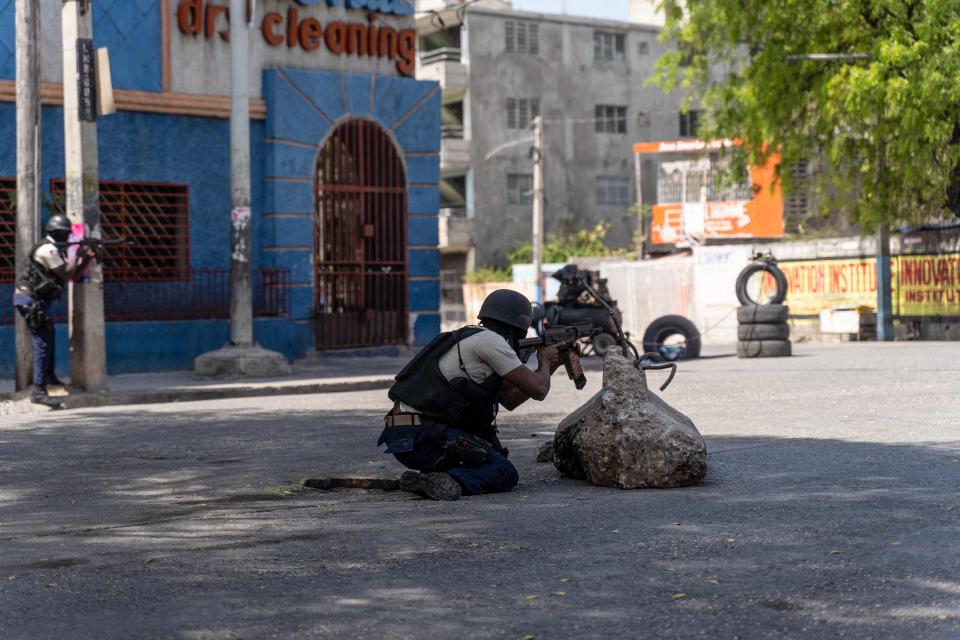 Haitian National Police take positions as they attempt to repel gangs in a neighborhood near the Presidential Palace in the center of Port-au-Prince, Haiti on March 3, 2023.