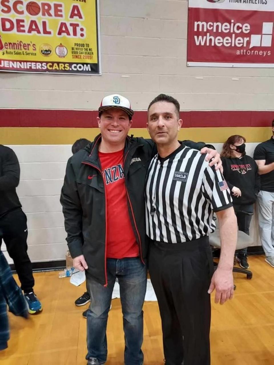 Friend Kyle Perkins poses for a photo with referee Tony Wise, who recently died from cancer.