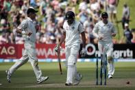 India's Rohit Sharma (C) reacts after being dismissed during the first innings on day two of the second international test cricket match against New Zealand at the Basin Reserve in Wellington, February 15, 2014. REUTERS/Anthony Phelps (NEW ZEALAND - Tags: SPORT CRICKET)