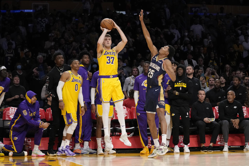 Los Angeles Lakers forward Matt Ryan (37) shoots and make a three-point shot to send the game to overtime as New Orleans Pelicans guard Trey Murphy III defends during the first half of an NBA basketball game Wednesday, Nov. 2, 2022, in Los Angeles. (AP Photo/Mark J. Terrill)