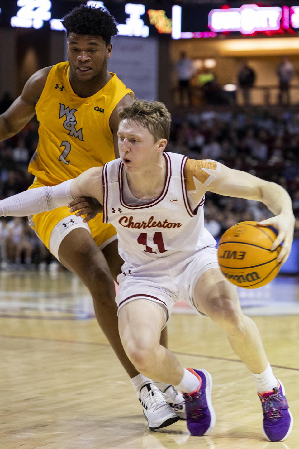 College of Charleston's Ryan Larson (11) dribbles against the defense of William & Mary's Chase Lowe (2) in the first half of an NCAA college basketball game in Charleston, S.C., Monday, Jan. 16, 2023. (AP Photo/Mic Smith)