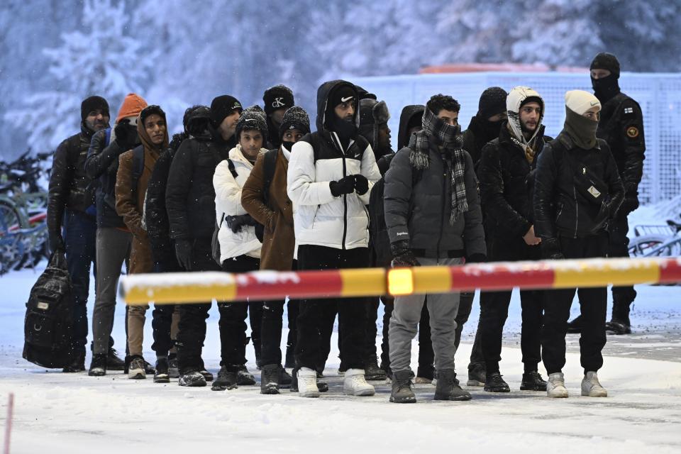 Migrants arrive at the international border crossing between Finland and Russia, in Salla, Finland, Thursday, Nov. 23, 2023. (Jussi Nukari/Lehtikuva via AP)