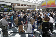 Travelers wait in line to go through a security checkpoint at Orlando International Airport, Wednesday, Nov. 21, 2018, in Orlando, Fla., before the start of the Thanksgiving holiday (AP Photo/John Raoux)