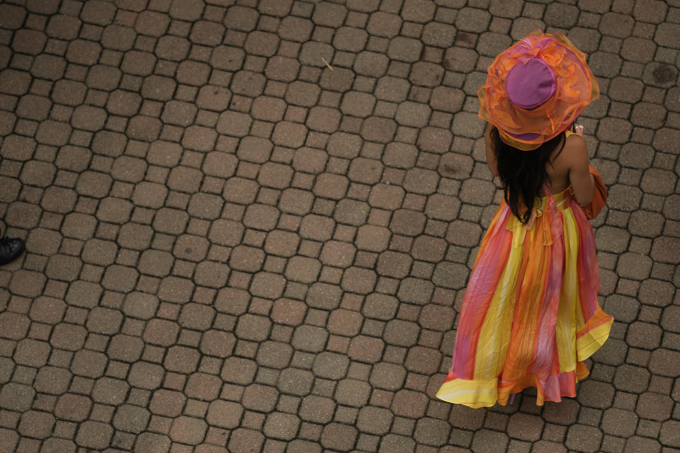 A race fan walks though the grounds of Churchill Downs before the 150th running of the Kentucky Derby horse race Saturday, May 4, 2024, in Louisville, Ky. (AP Photo/Charlie Riedel)