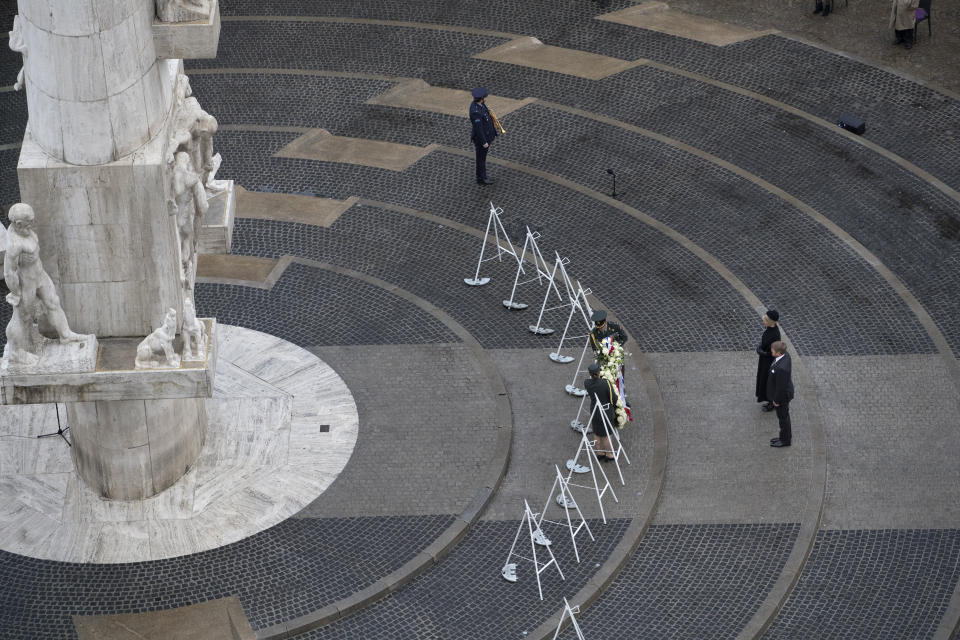 View of Dam Square devoid of spectators due to coronavirus related restrictions, as Dutch King Willem-Alexander and Queen Maxima lay a wreath during a national service to commemorate the war dead in Amsterdam, Netherlands, Tuesday, May 4, 2021. (AP Photo/Peter Dejong, Pool)